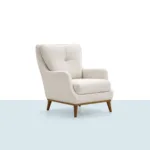 Toskana Berjer – krem renkli, yumuşak dokulu kumaş ve ahşap ayaklı tekli koltuk (tek ürün görseli)